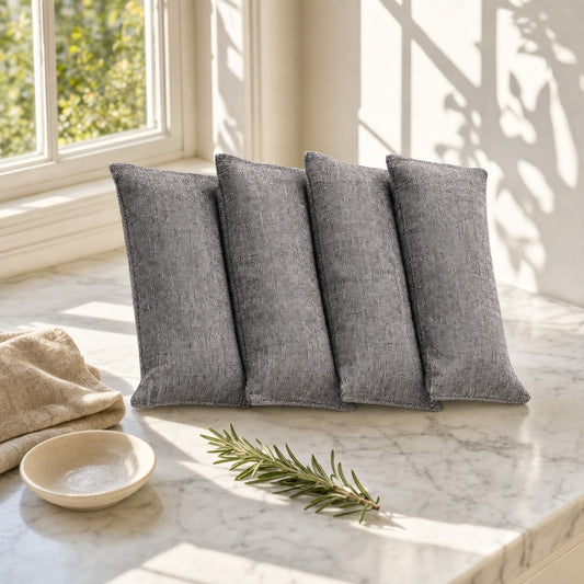 Grey bamboo charcoal bags on a sunlit marble counter