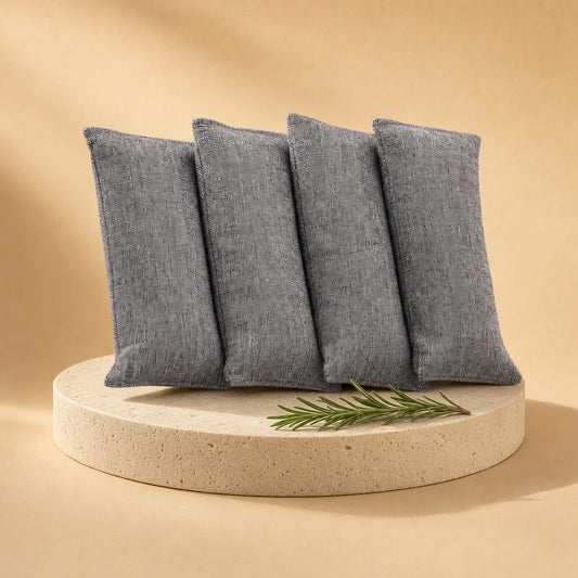 Grey bamboo charcoal bags on a stone pedestal
