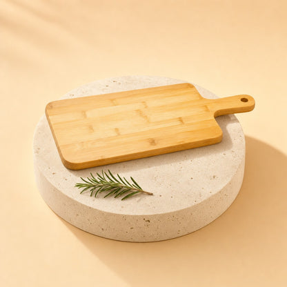 Bamboo cutting board with handle on a stone pedestal