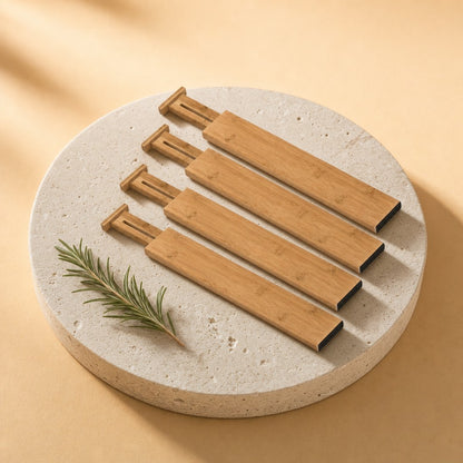 Four adjustable bamboo drawer dividers on a stone pedestal