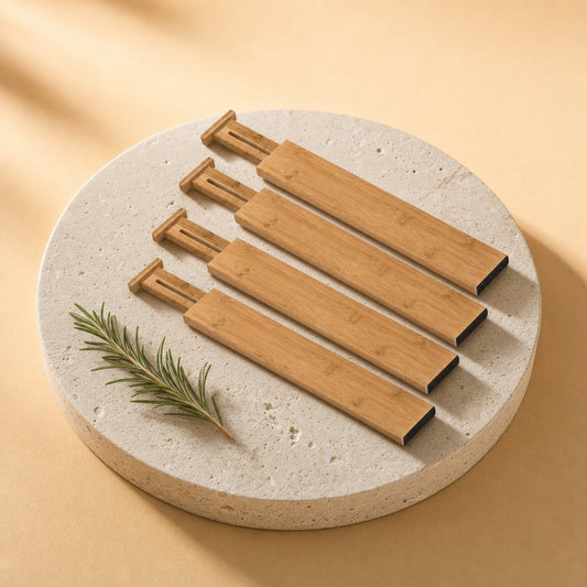 Four adjustable bamboo drawer dividers on a stone pedestal