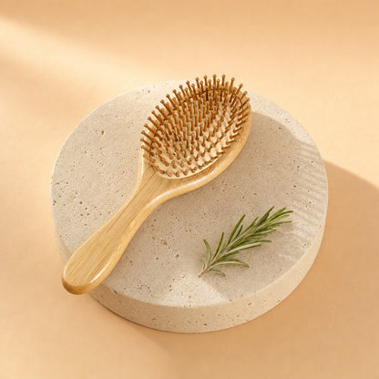 Bamboo paddle hairbrush on a stone pedestal