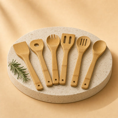 Six bamboo cooking utensils on a stone pedestal