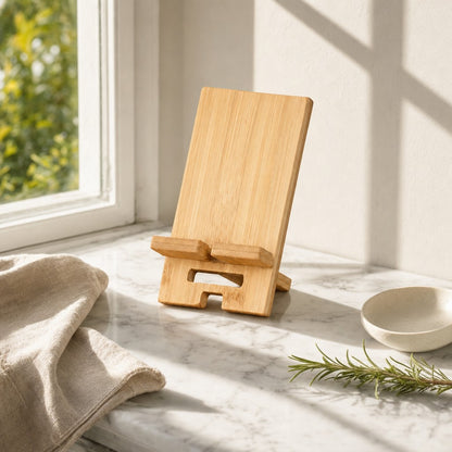 Bamboo phone stand on a sunlit marble counter