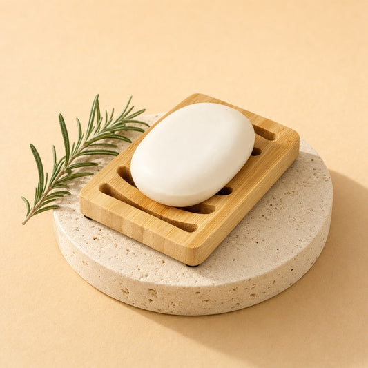 Bamboo soap dish with a bar of soap on a stone pedestal