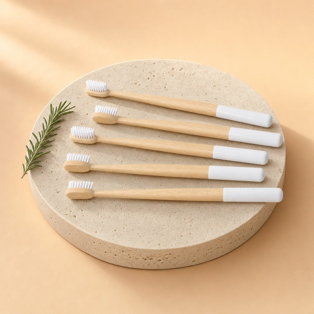 Five bamboo toothbrushes on a stone pedestal