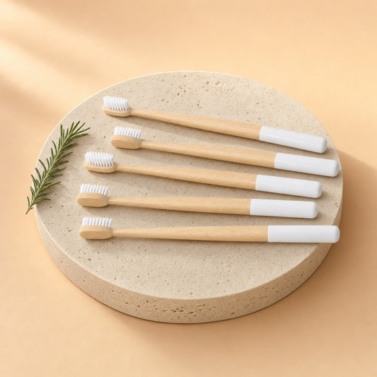 Five bamboo toothbrushes on a stone pedestal