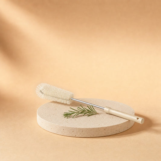 Long-handle bottle brush with wooden handle on a stone pedestal
